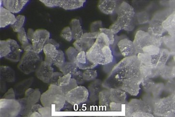 Photo micrograph of calcite sample showing more rounded particles