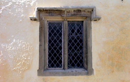 Stone mullioned window with leaded lights set in a rendered and limewashed wall