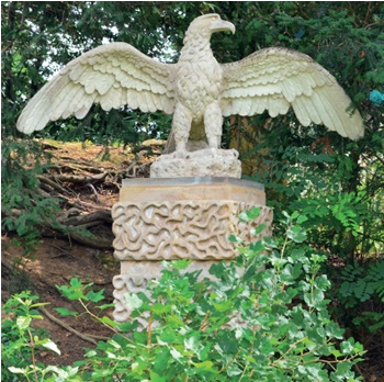 Stone eagle with open wings mointed on rusticated plinth