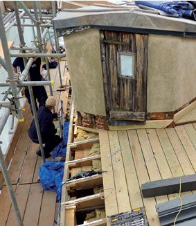Bat hotel under construction with voids visible between rafters where final deck boards have not been re-laid to roof edge