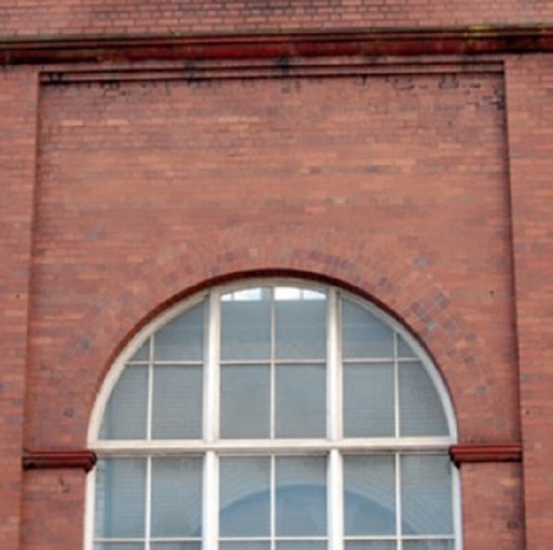 Pressed facing bricks around window