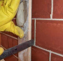 Close-up of Frenchman being used to trim a perpend or vertical joint