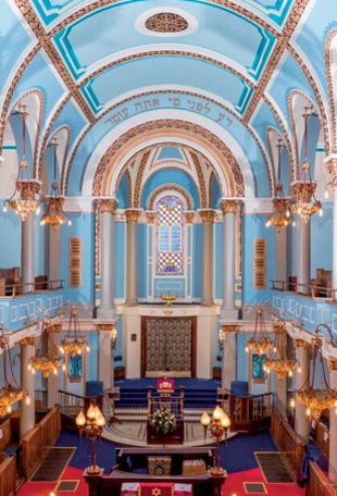 The barrel-vaulted ceiling and striking light blue and gold colour scheme of Singers Hill Synagogue, Birmingham