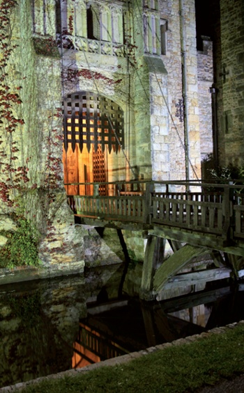 Hever Castle at night with moat, drawbridge and portcullis