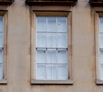 Sash window viewed from exterior with interior shutters closed