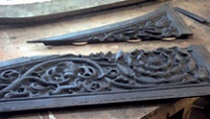 Two elements of a carved timber spandrel with wooden biscuits protruding from edge of one