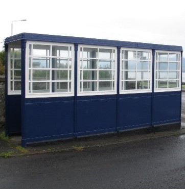 Bus shelter constructed from cast iron sections and with blue and white paint scheme