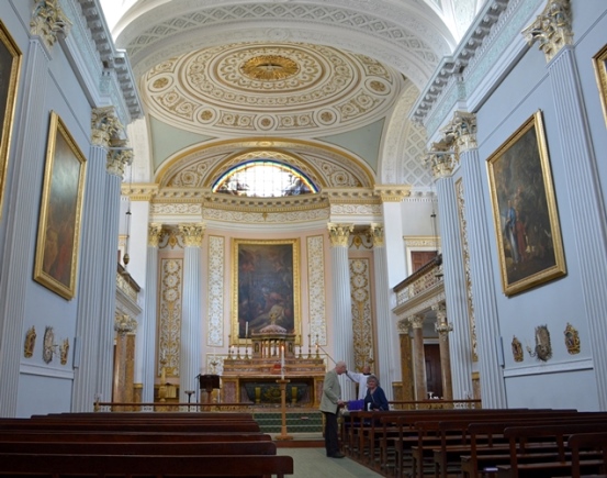 The fine gilded plaster decoration, pilasters and saucer-domed ceiling of the chapel interior