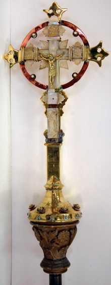 Elaborately detailed processional cross in brass with carved wooden staff