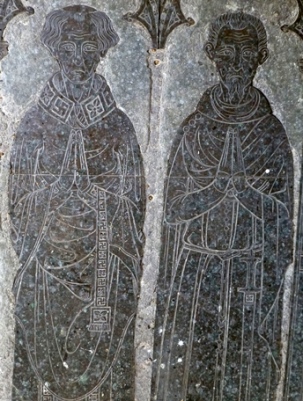 Brass with badly pitted and tarnished surface showing two praying men