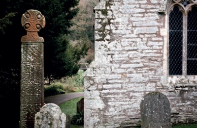 Stone monuments including a Celtic cross in a Welsh churchyard