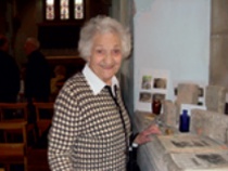 Elderly visitor with church history display