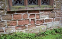 Eroded masonry with cement pointing intact