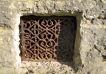Metal air vent in masonry wall