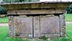 Elevation view of chest tomb showing extensive stone loss along upper edge of side panel