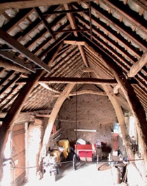 Cruck barn interior showing two of the A-shaped crucks