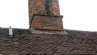 Mortar fillets around base of brick chimney stack