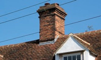 Lead flashings at base of brick chimney stack