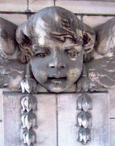 Carraraware cherub with heavy soiling and areas of crazing