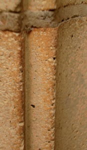 Close-up of terracotta surface showing pale orange colouring and surface pores