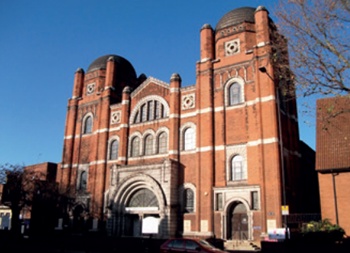 Plaistow exterior: red brick with stone dressings; flanking square-section towers topped by polygonal turrets and domes