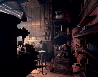 Dimly lit jewellery workshop filled with tools and machinery