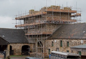 Historic fortified farmhouse scaffolded for repair