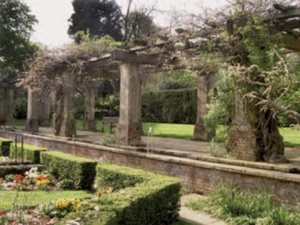 Brick and stone pergola, box hedge and rill with fountain jets at Stoke Poges Gardens of Remembrance