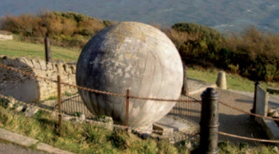 Massive Purbeck stone globe overlooking the coast at Durlston Castle