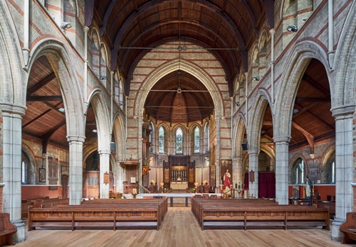 View through the nave towards the chancel, with pale oak flooring to nave