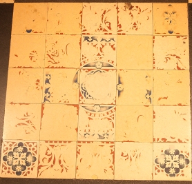 Panel of worn tiles: several have little or no surviving pattern