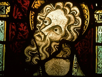 Detail of stained glass window showing the bearded and haloed head of a prophet
