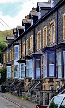 Terraced houses with bay and dormer windows, some in timber others in aluminium