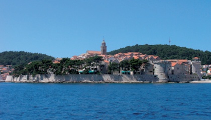 Korčula town viewed from the sea with wooded hills rising in the background