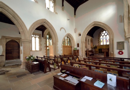 Nave with movable pews; timber and glass walled office in background