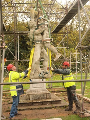 A classical sculpture is winched from its plinth for conservation