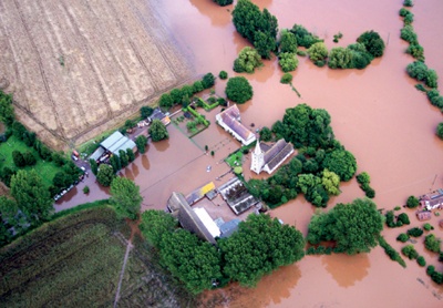 Aerial photograph showing church and nearby farm buildings surrounded by floodwater