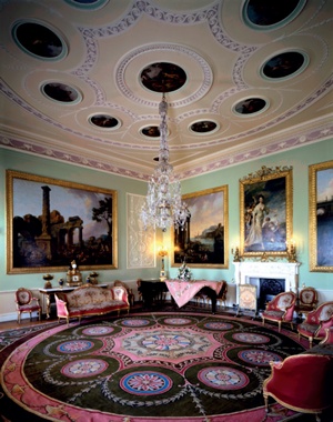 Harewood's Music Room: the carpet has dominant pinks and browns and features ten colourful medallions which are mirrored in the pattern of the plasterwork ceiling