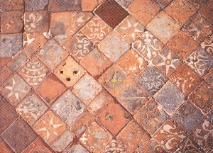 Badly worn tiles at Winchester Cathedral decorated in a wide variety of patterns