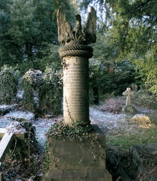 Neoclassical memorial incorporating an inscribed column with a rope moulding to the top surmounted by a rising Phoenix