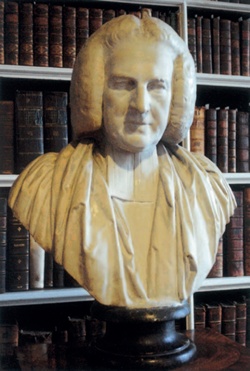 Portrait-bust of Archbishop Robinson with library bookshelves behind