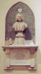 Portrait-bust of Primate Robinson atop an inscribed, wall-mounted plinth backed by a dark-grey panel with a pointed top