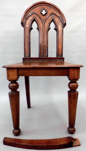 Mahogany chair with detached rear leg lying in front of it
