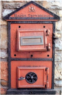 Cast-iron stove front set into wall as letter box