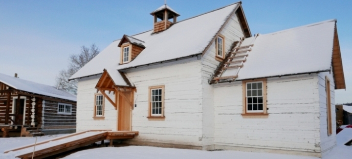 Small timber church with snow-covered roof