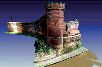Image shows elements of sandstone King Charles Tower and adjacent wall sections, pavement and canal in foreground