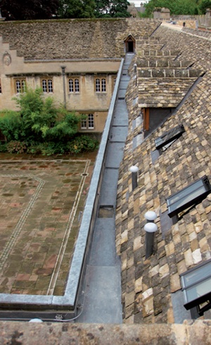 A run of lead-lined parapet gutter viewed from the roof ridge