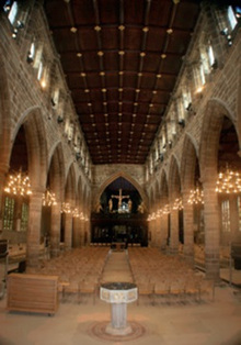 A warm, golden light is produced by the LED pendants hung in the aisle archways of Wakefield Cathedral