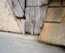 Gaps and signs of rot in the belfry's timber frame