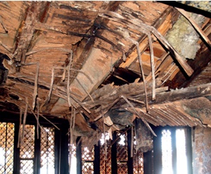 Scorched ceiling laths and partially collapsed supporting timbers